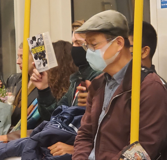Man of the Tube with woman reading Outbreak