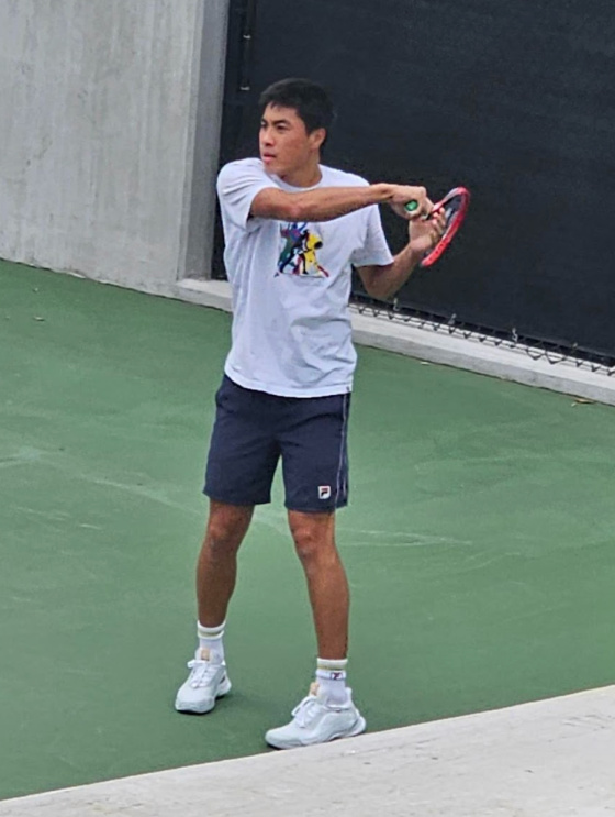 Brandon Nakashima finishing a forehand
